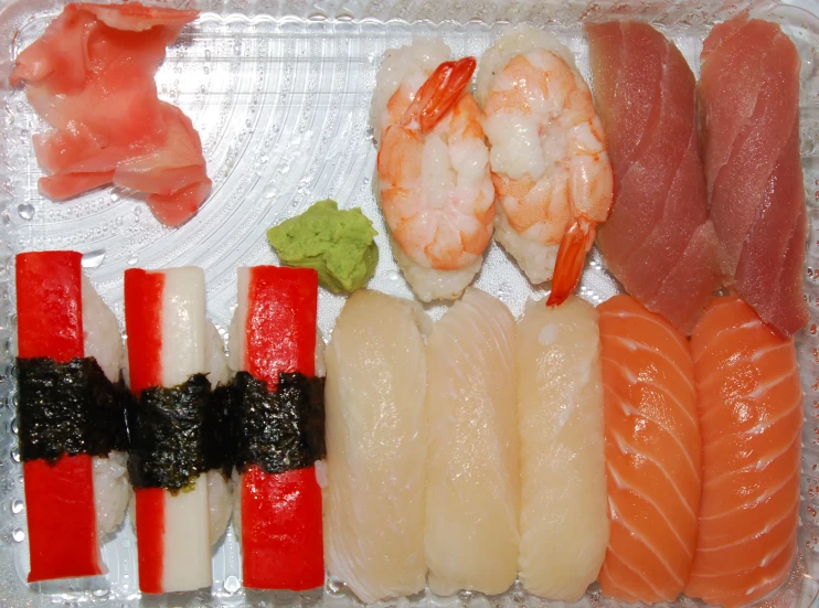 some sashimi and chopsticks are sitting on the plate