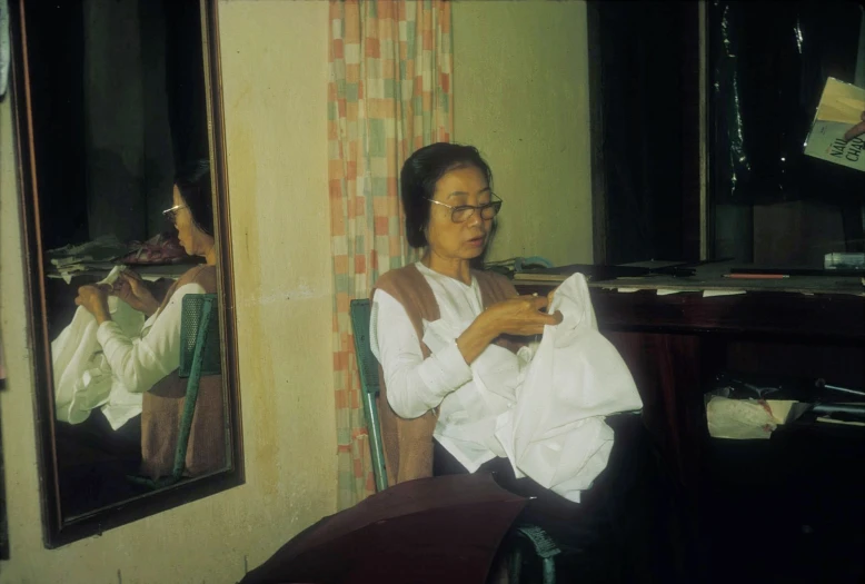 a woman sitting in a chair holding soing