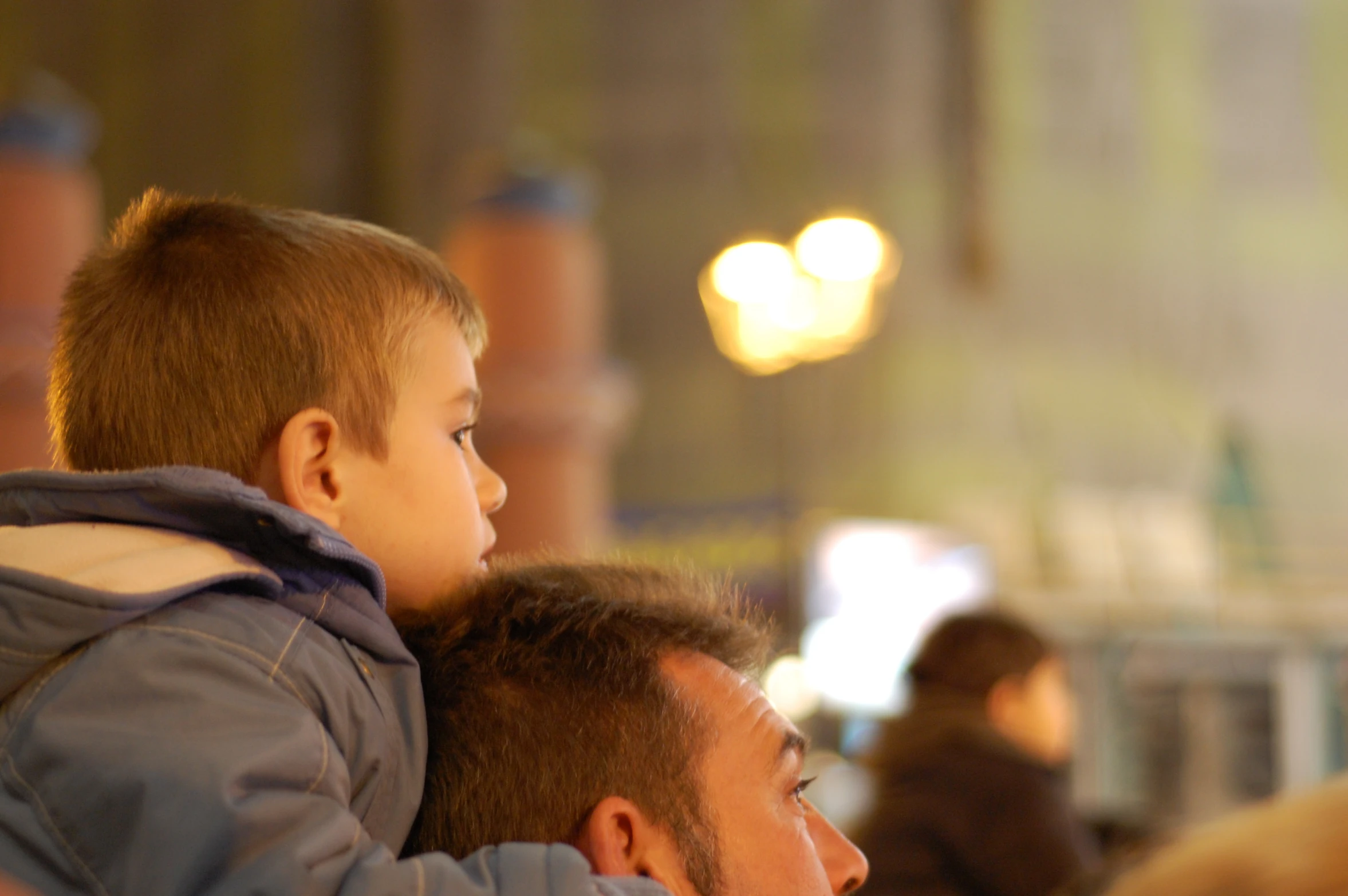 a young child is holding an adult next to him