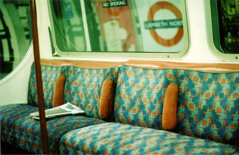 an empty bus seat with a paper on it