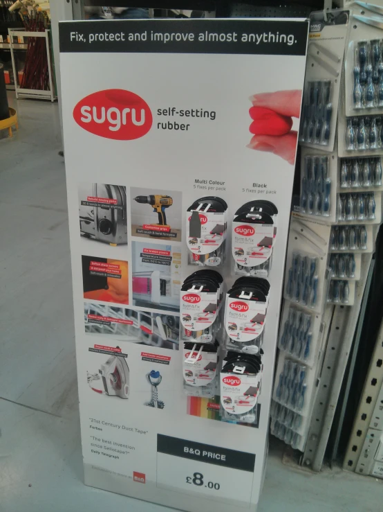 a sign advertising a sugi store with many items in display