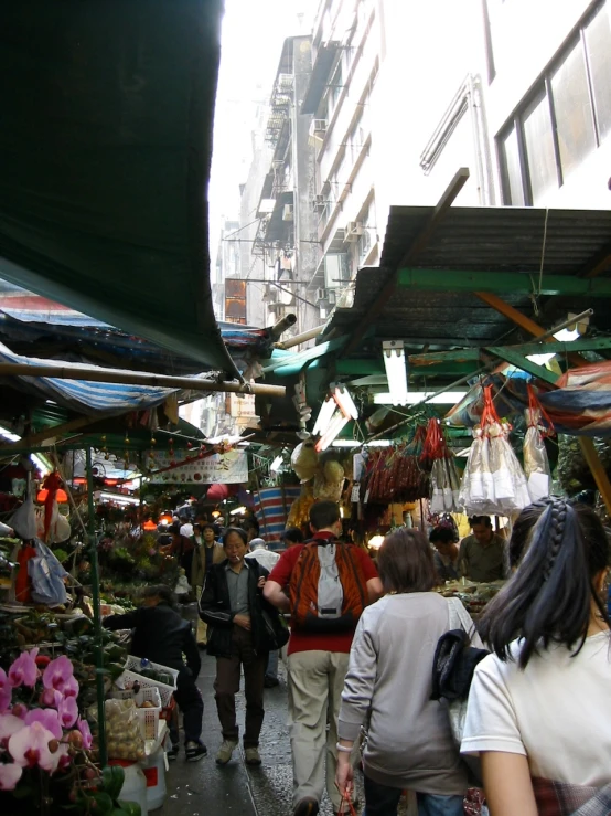 a crowded outdoor market selling various types of goods