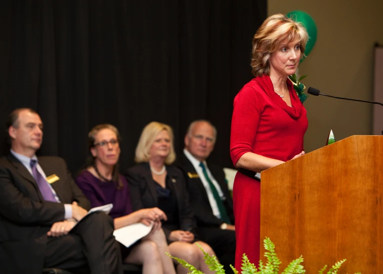 there is a woman at a podium with microphone