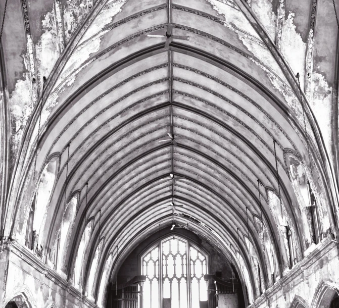 a very long church with an arched wall and large window