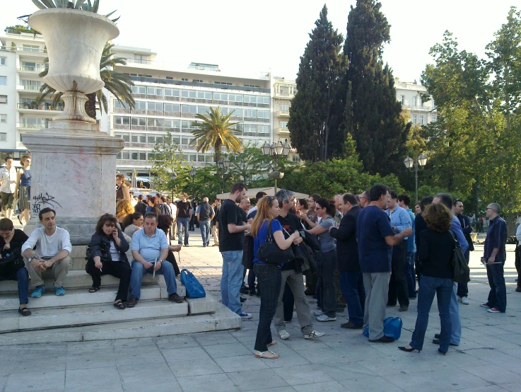 many people are standing on the steps outside of the building