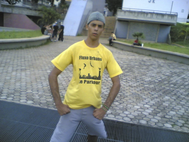 man in yellow shirt on a paved area with many steps