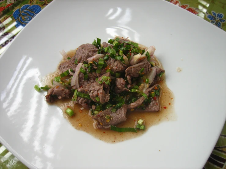 a white plate filled with rice and meat