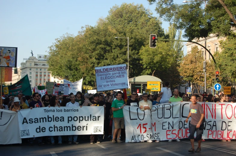 group of people standing around holding up large banners