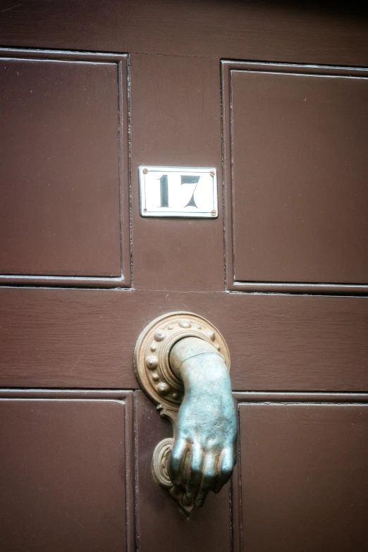 the hand of a persons arm is attached to a door handle