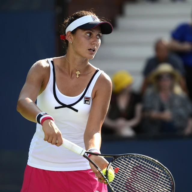 a young female tennis player is in action