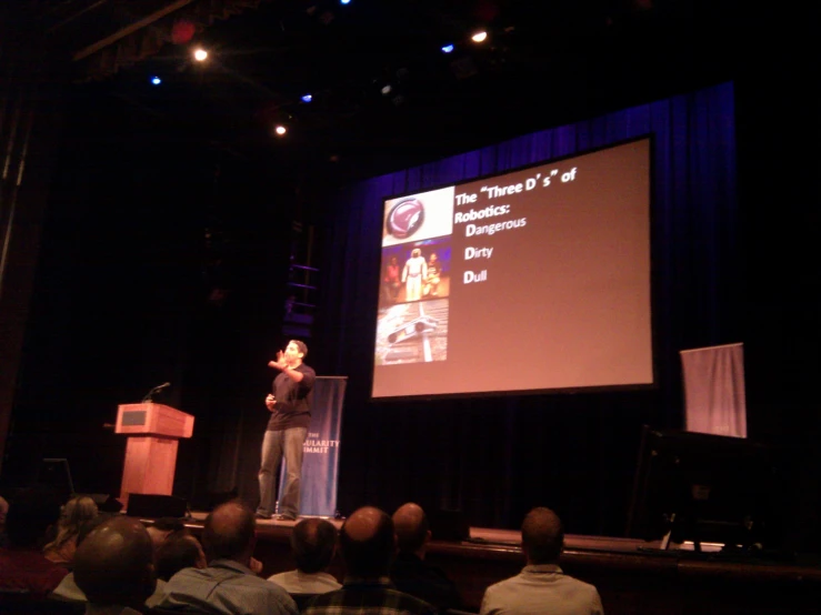 a man is giving a presentation on stage