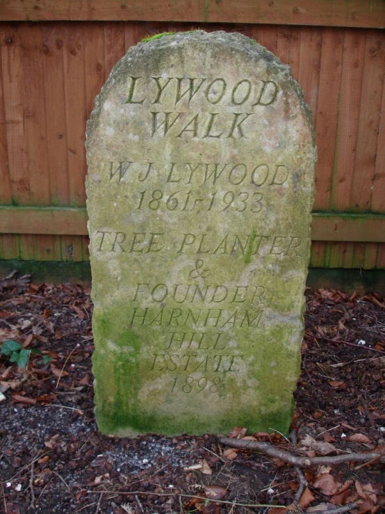 the headstone to lynwood walk in a garden