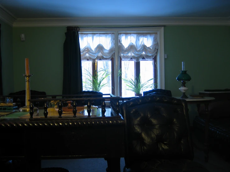 a room filled with a brown chair and large windows