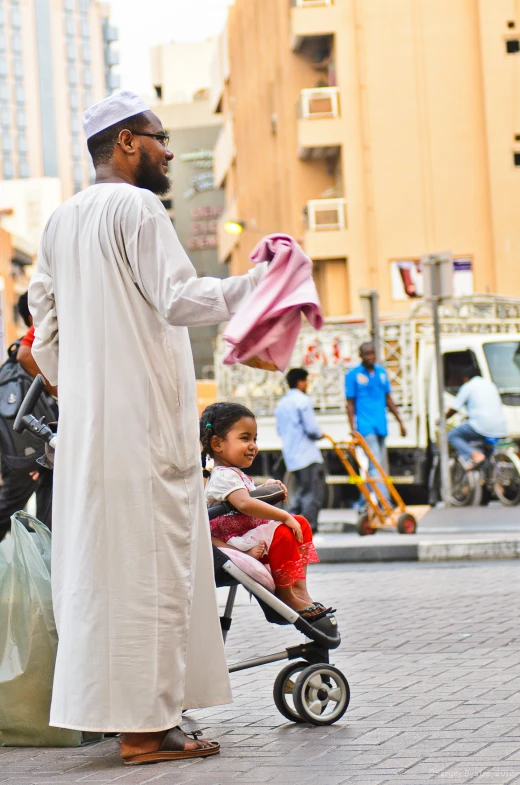 a man and child on a street side walk