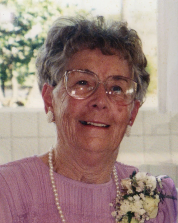 a very old woman with a pretty flower