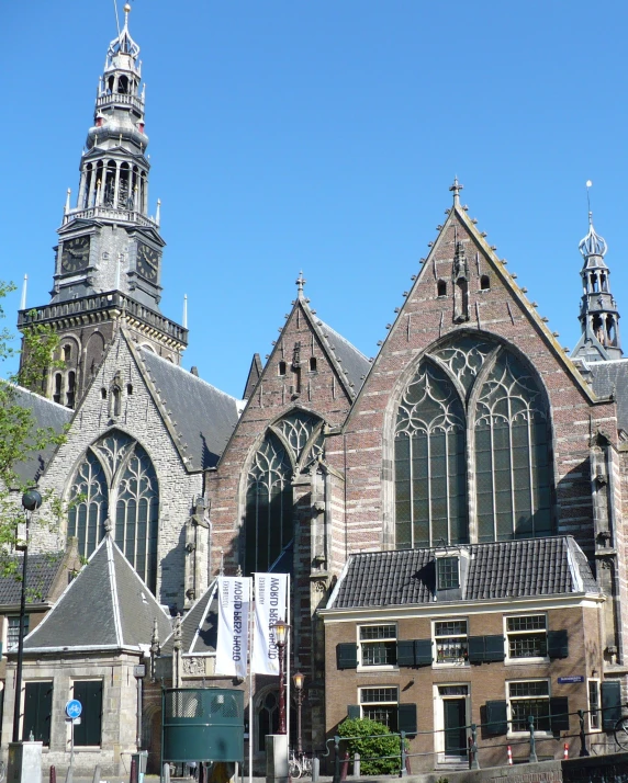 an old church with some clocks and a cross on it