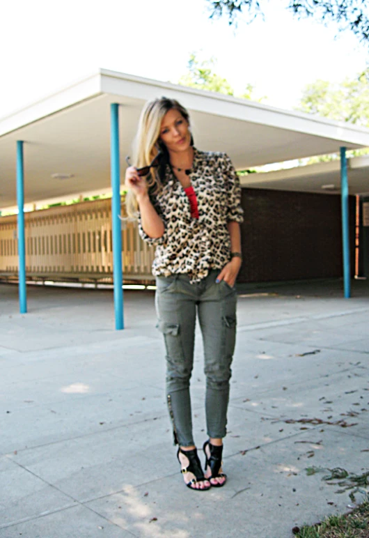 a girl standing on the side walk near a car