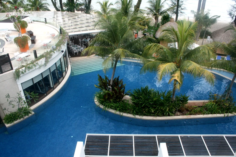 an aerial view of an outdoor swimming pool and patio