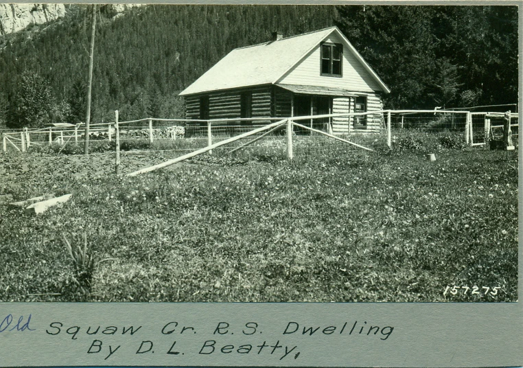 an old black and white po with a house