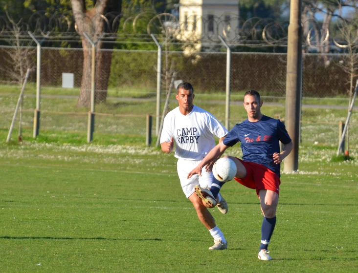 the men are playing soccer on the field