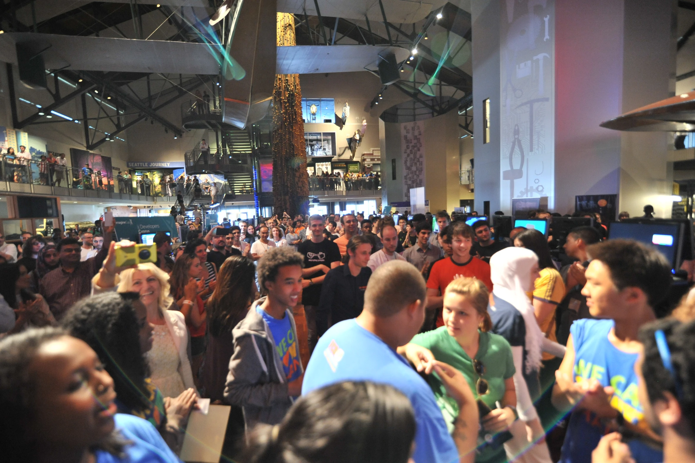 crowd of people standing around in convention center