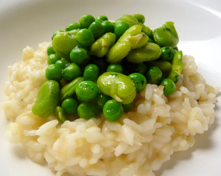 a plate of rice and peas with garnishes