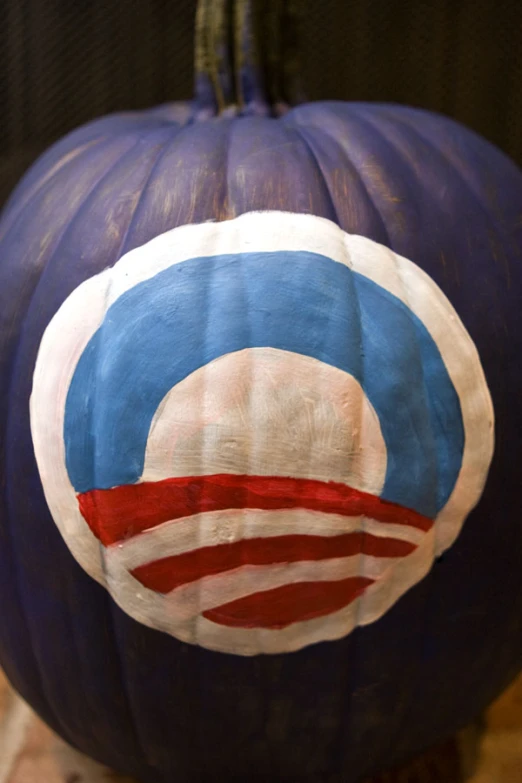 a close up of a large blue pumpkin with a flag painted on it