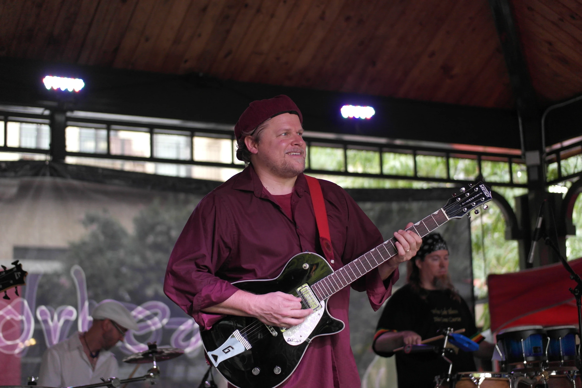 a man with an electric guitar in front of people