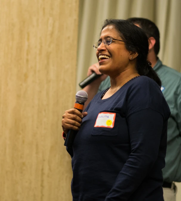 a woman standing in front of a microphone