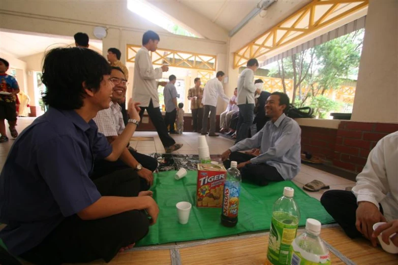 a man sitting on the floor near another man