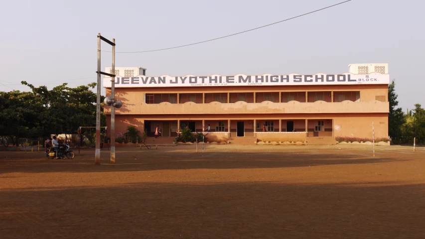 the building has several windows and a sign reading jeevan at the high school