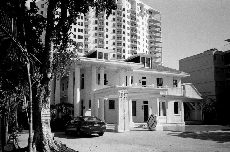 an old, run down building sits in the middle of an empty street