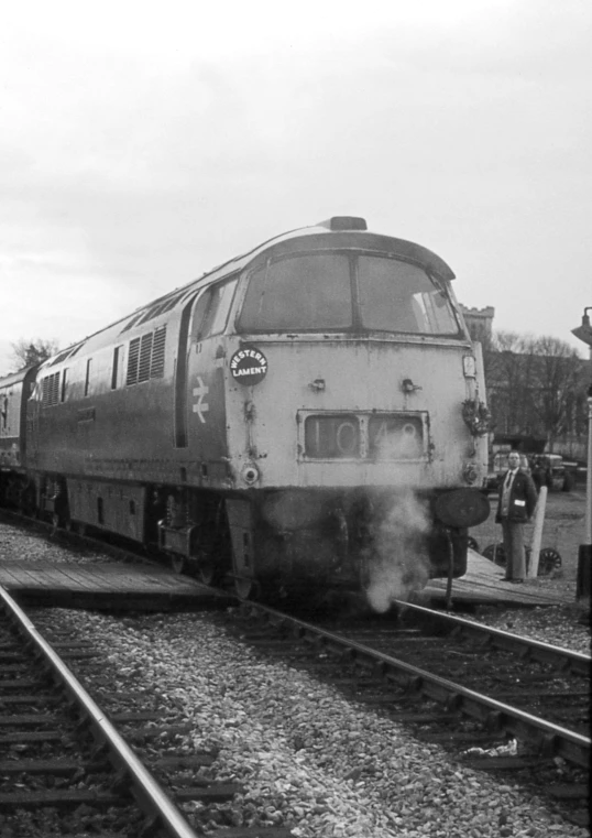 a passenger train on the tracks, leaving a station