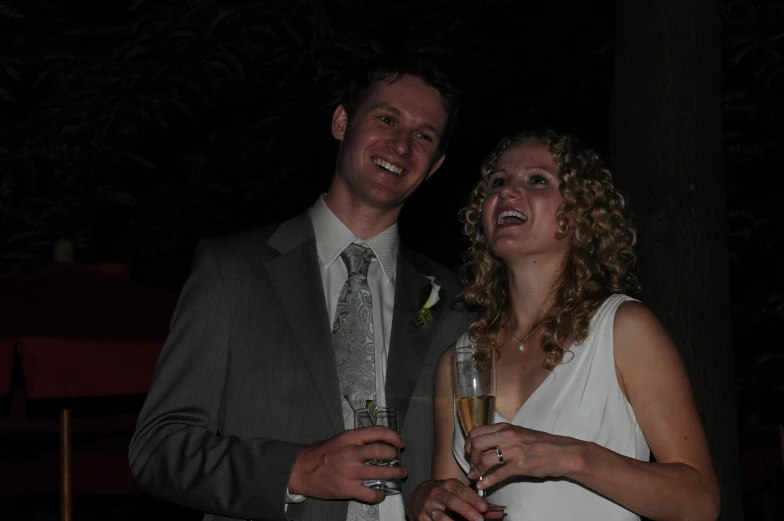 a man and woman holding champagne at a formal event