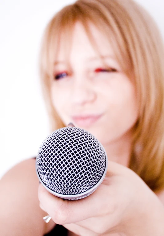 the woman is holding a black and white microphone