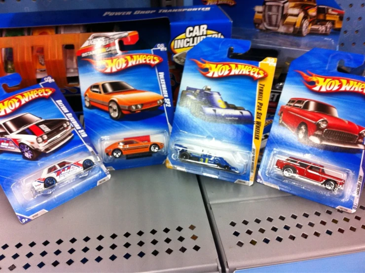 some cars on a store shelf in front of each other