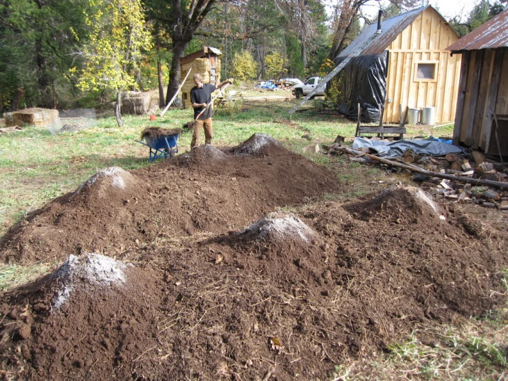 a man digging the dirt in his yard