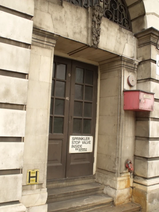 an entrance to a building with two windows