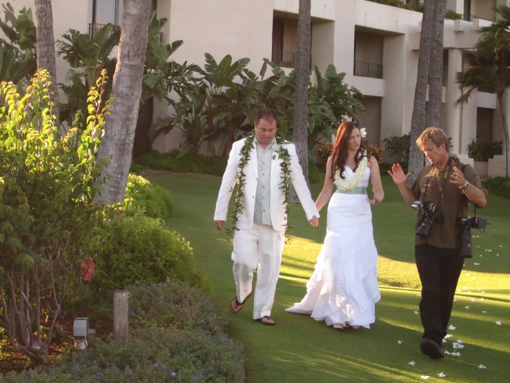 a man and woman are walking away from the ceremony