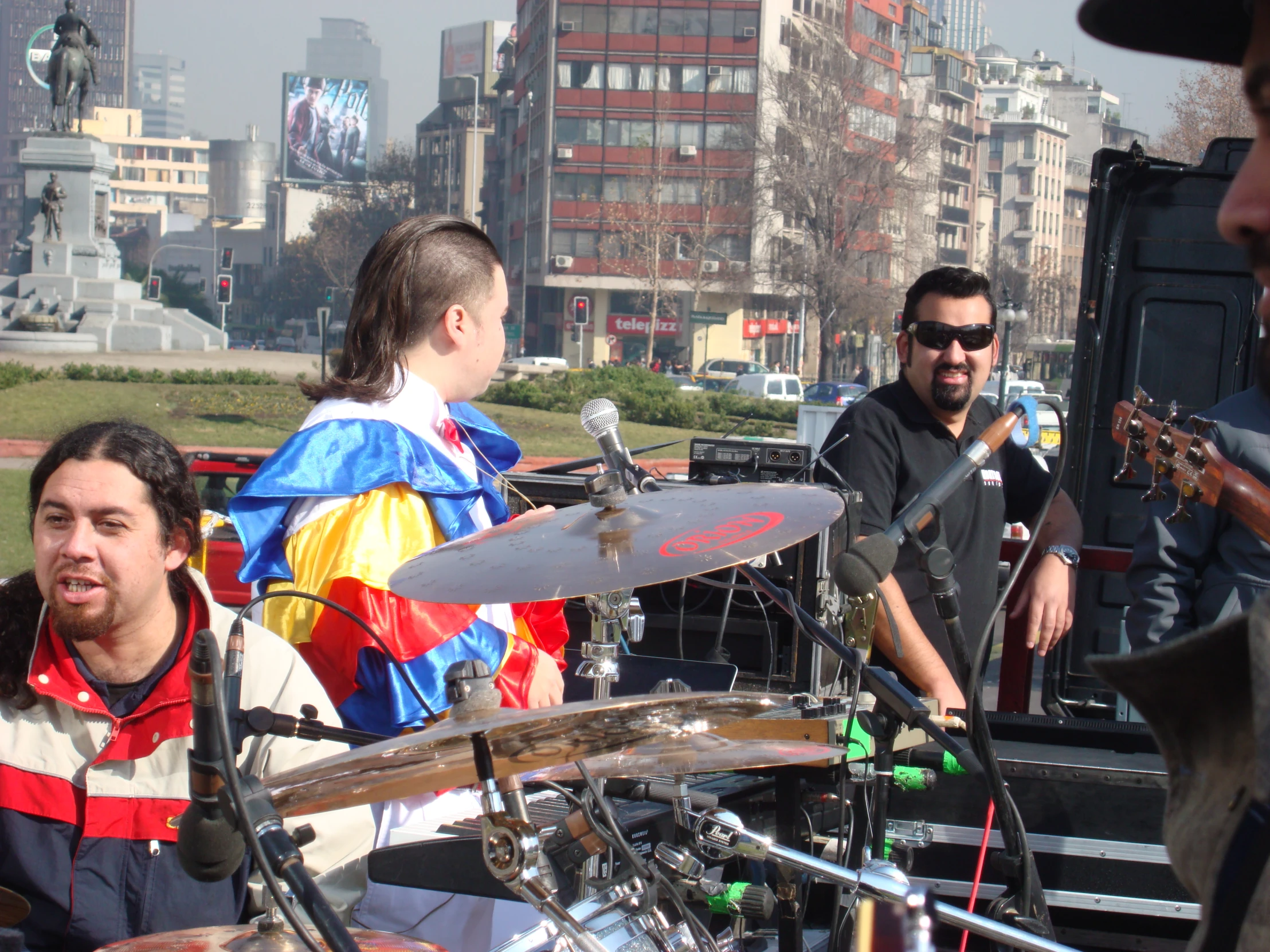 people standing in a crowded area and playing guitars