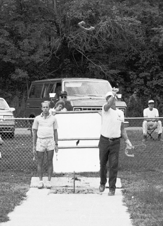 an older couple is standing on a baseball field