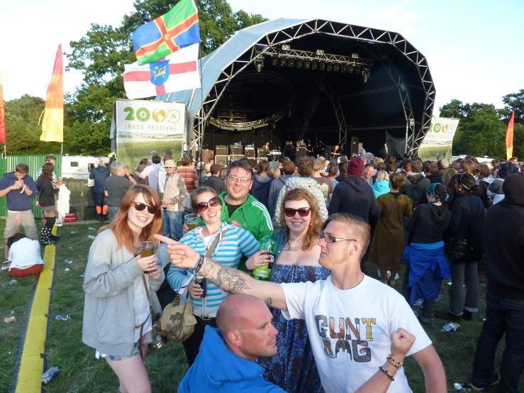 a crowd of people outside near a stage