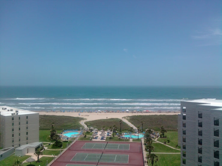 a tennis court near the beach and ocean