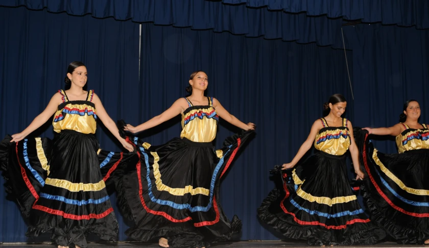 four women are dancing and posing for pictures