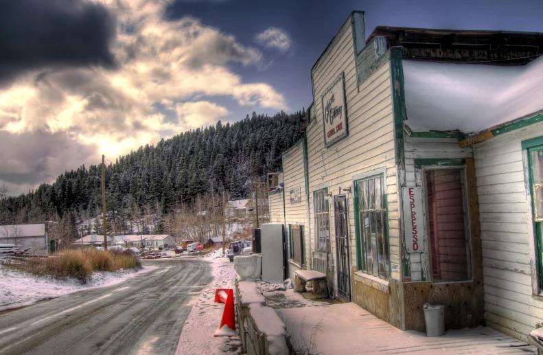 an old fashioned street scene with snow on the ground