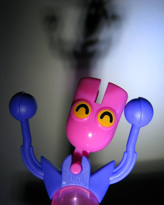 a pink toy sitting on top of a pink object