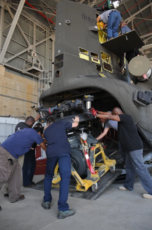 an overhead view of people working on parts and machinery