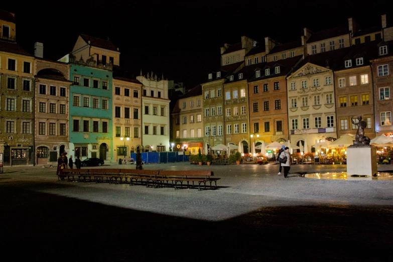 a square in a historic old city at night
