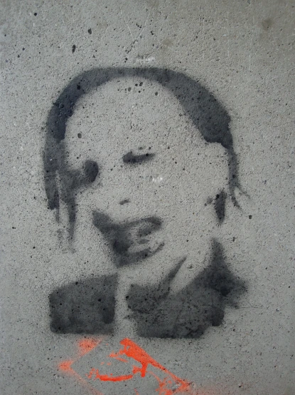 a graffiti is shown on the concrete of a wall