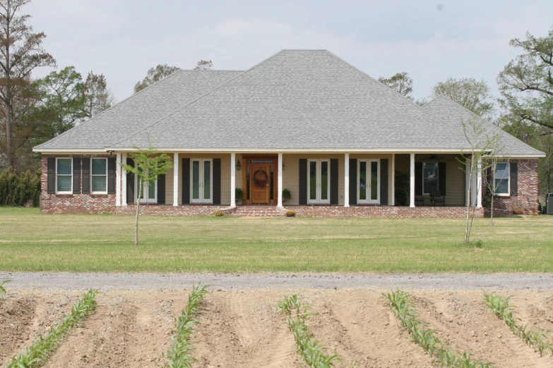 a home with an attached porch and many trees